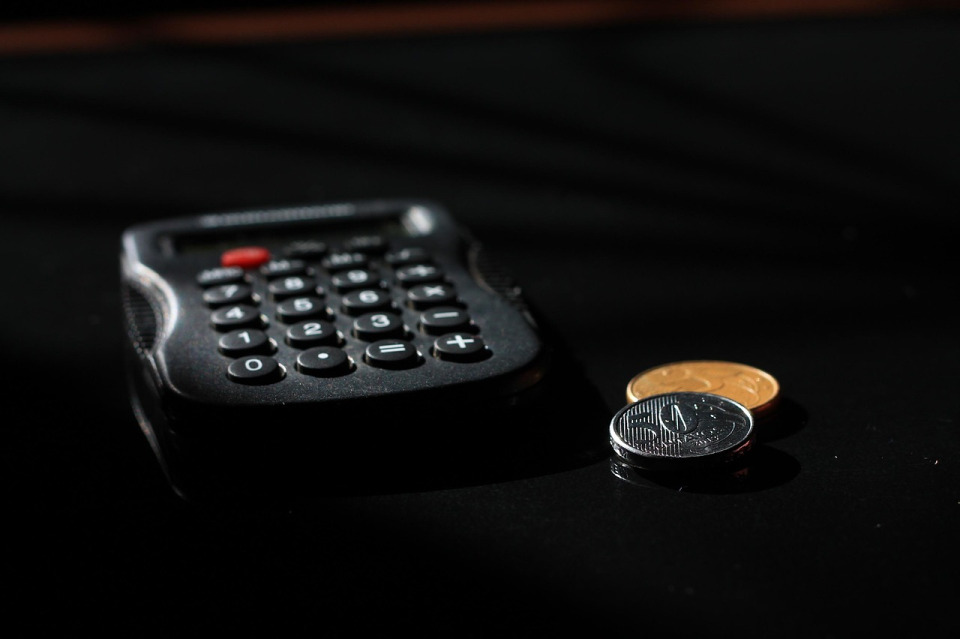 Paycheck and calculator showing unpaid wages